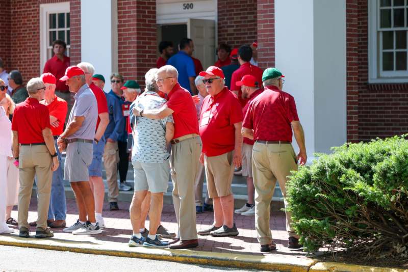 a group of people standing on a sidewalk