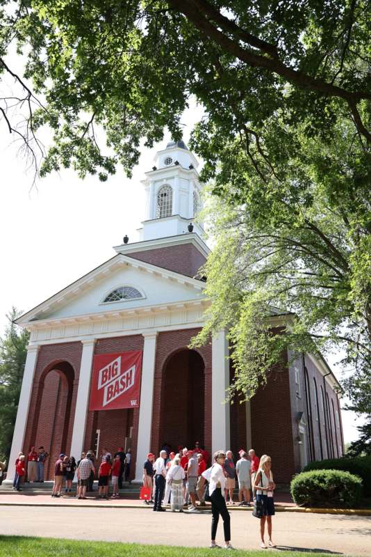 a group of people standing in front of a church
