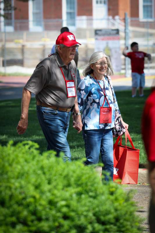 a man and woman walking on a sidewalk