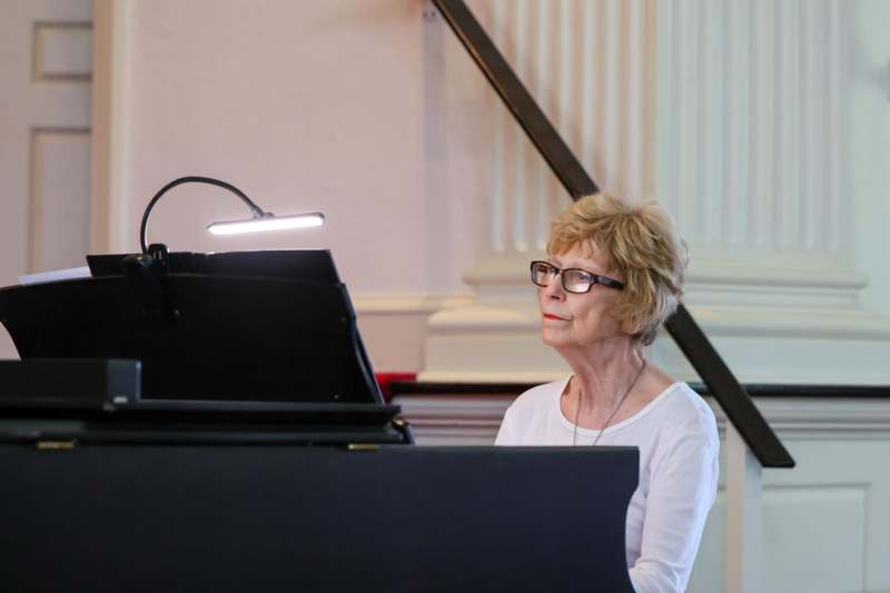 a woman sitting at a piano
