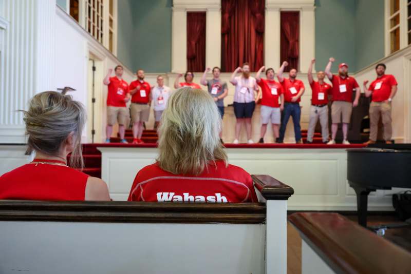 a group of people in red shirts