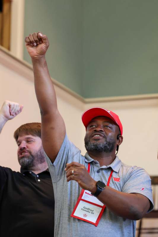 a man raising his arms up