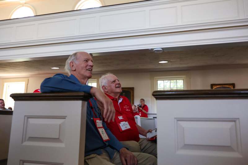 a group of men sitting in pews