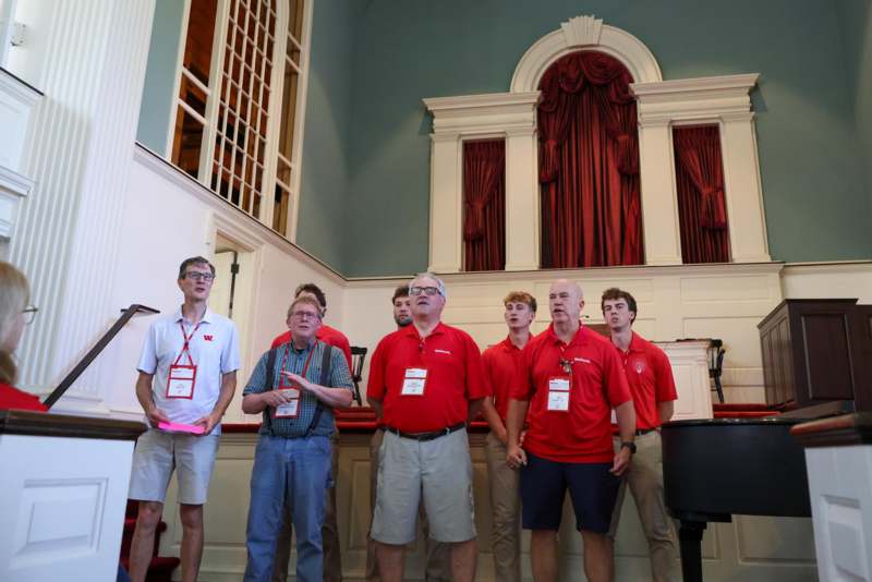 a group of people wearing matching red shirts