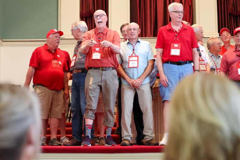 a group of men standing on a stage