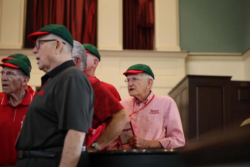 a group of men wearing green hats