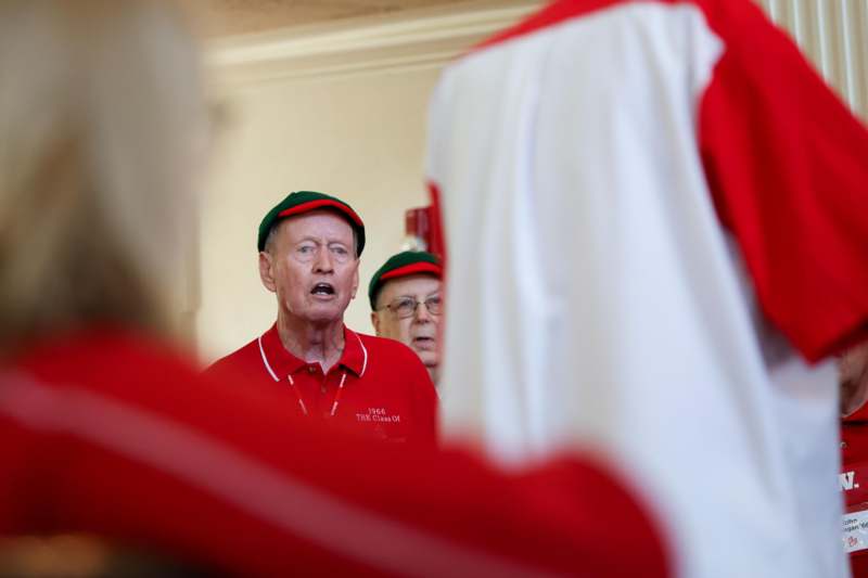 a group of men in red and green hats