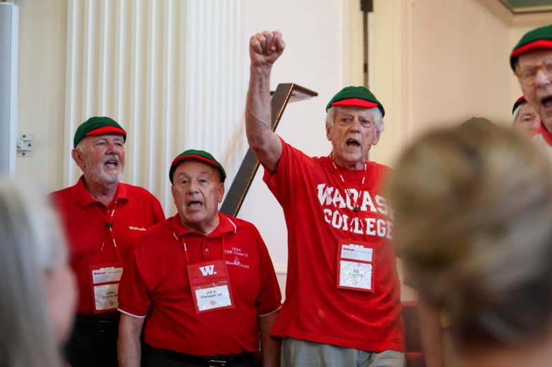 a group of men wearing matching red shirts