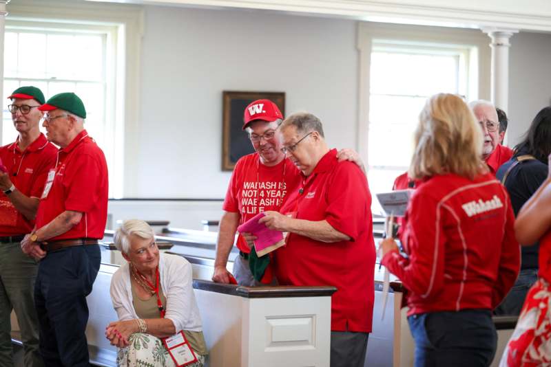 a group of people in red shirts