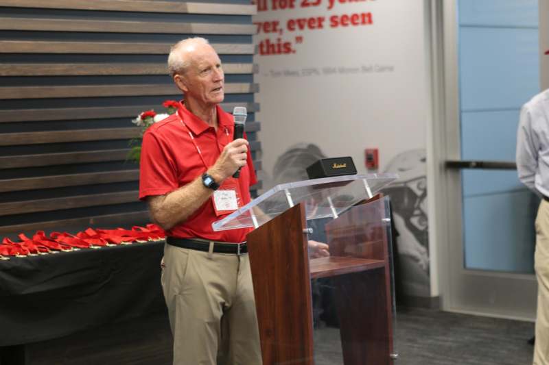 a man standing at a podium speaking into a microphone