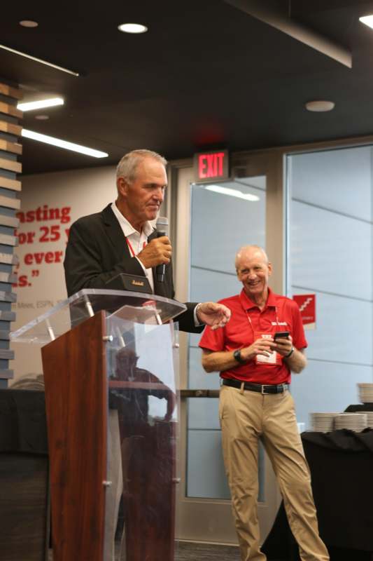 a man standing at a podium with a microphone