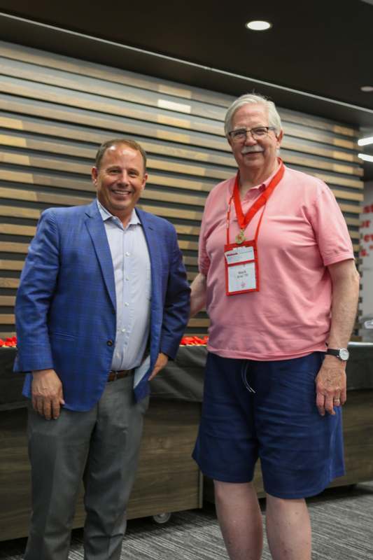 two men standing together smiling