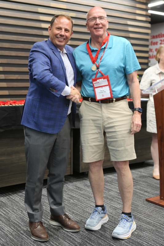 two men shaking hands in a room