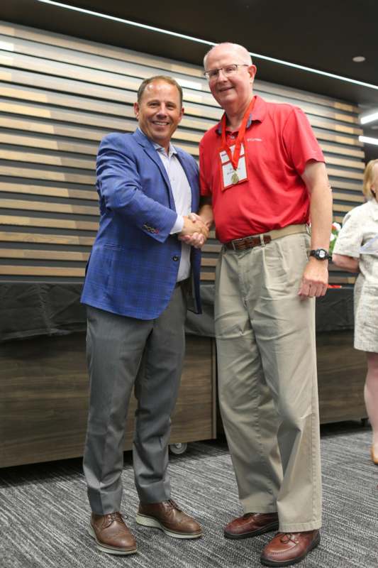 a man shaking hands with another man
