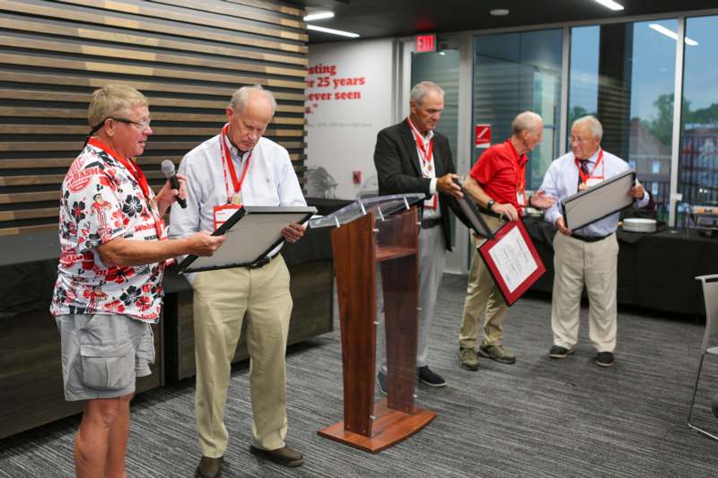 a group of people standing in front of podiums holding awards