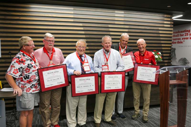 a group of people holding certificates