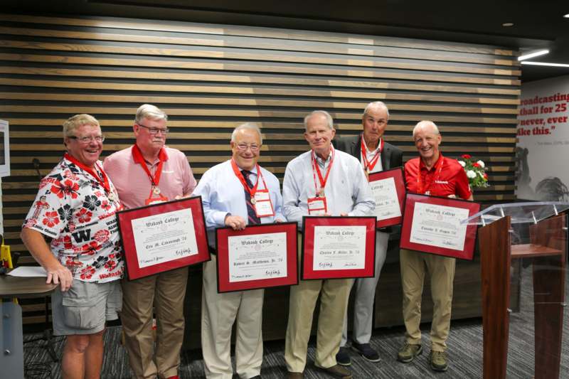 a group of people holding certificates