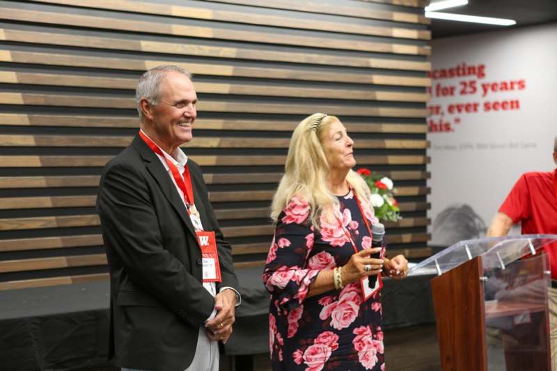 a man and woman standing next to a podium
