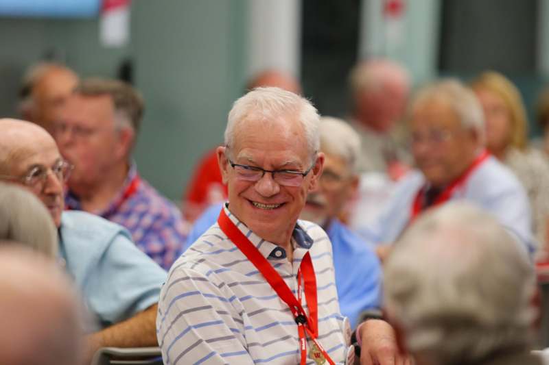 a man smiling at a conference
