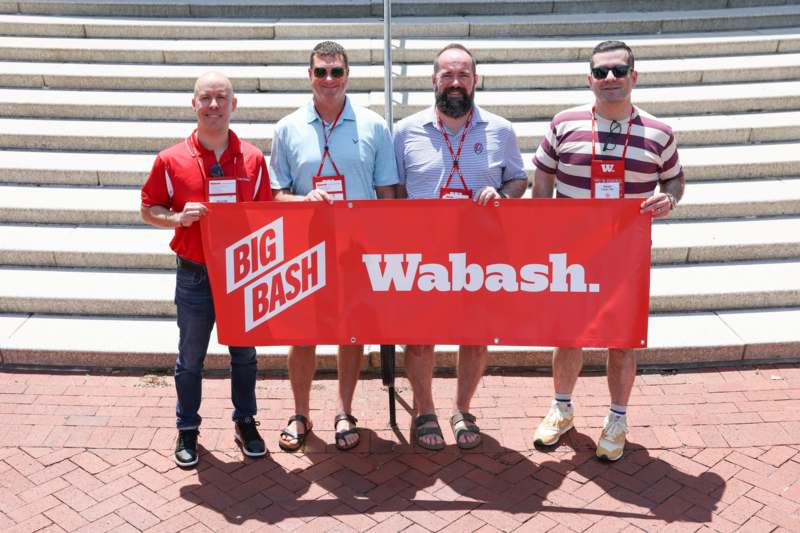 a group of men holding a banner