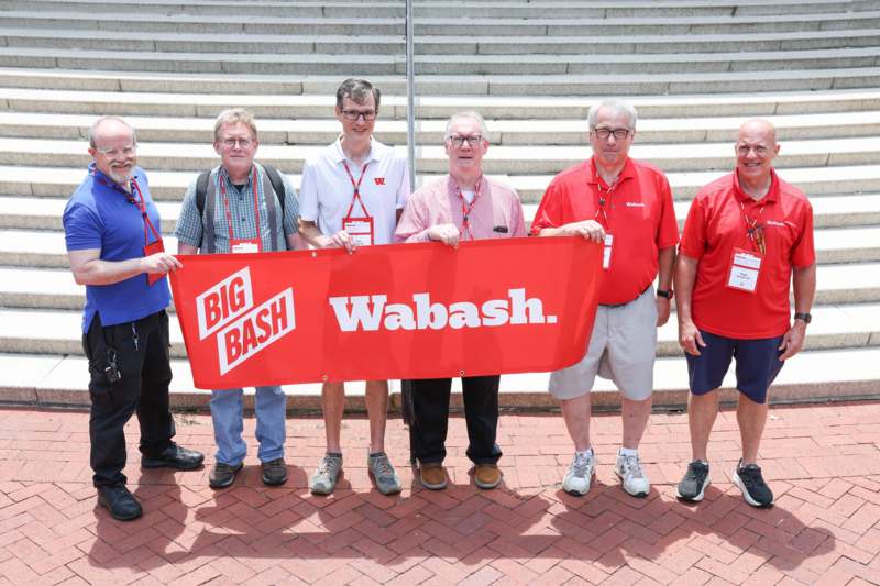 a group of men holding a banner