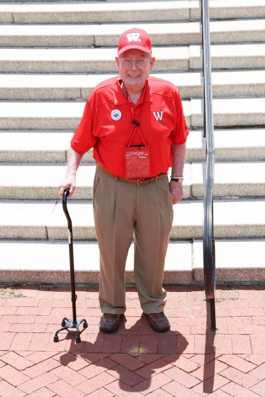 a man standing on stairs with a cane