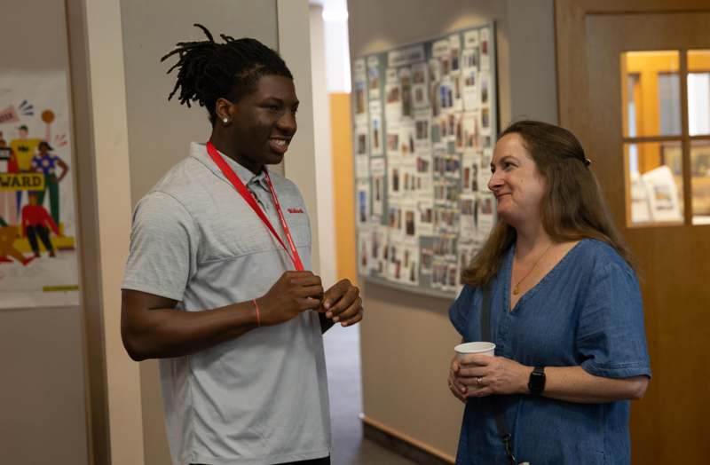 a man and woman standing in a hallway
