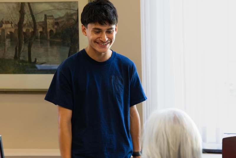 a man smiling at an old woman