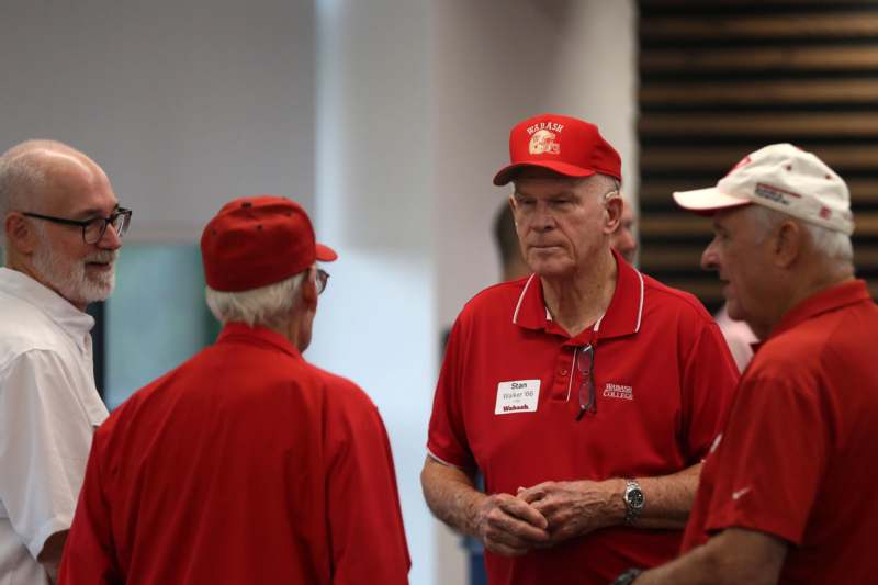 a group of men wearing red shirts and hats