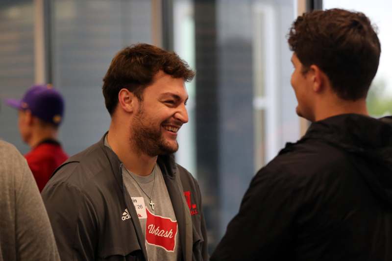 a man smiling at another man