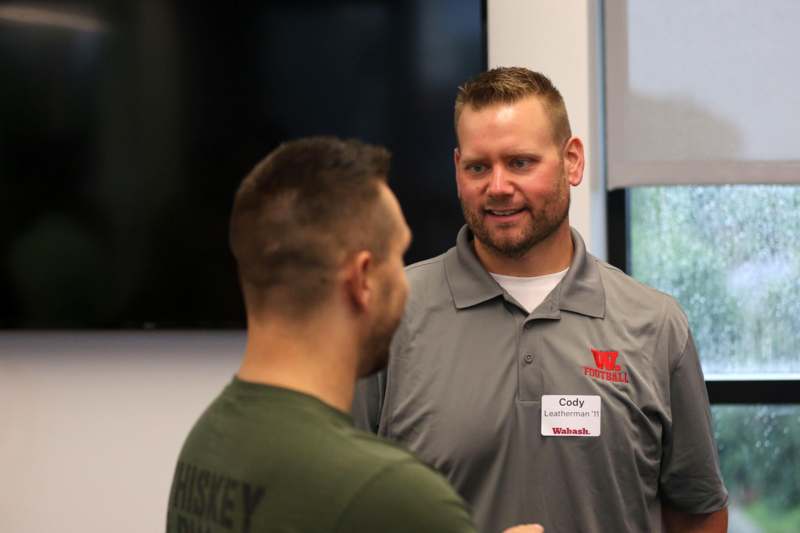 a man talking to another man