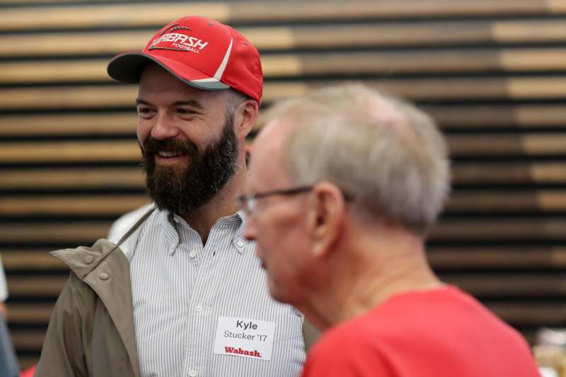 a man wearing a red hat and a white badge