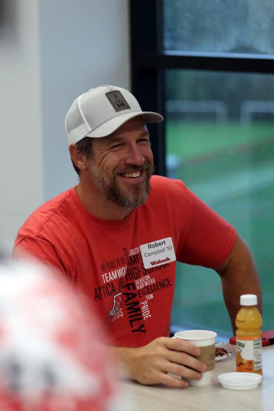 a man in a hat smiling