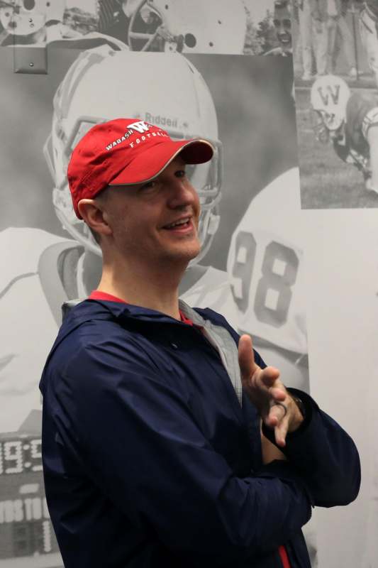 a man wearing a red hat and blue jacket