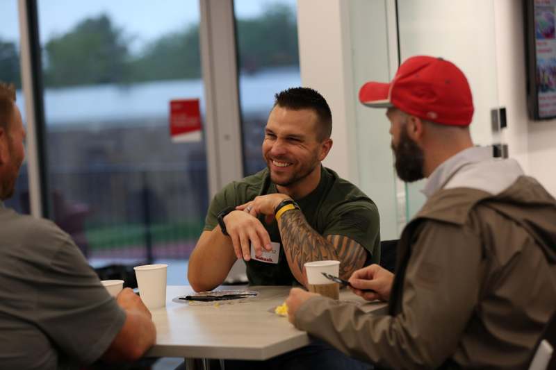 a group of men sitting at a table