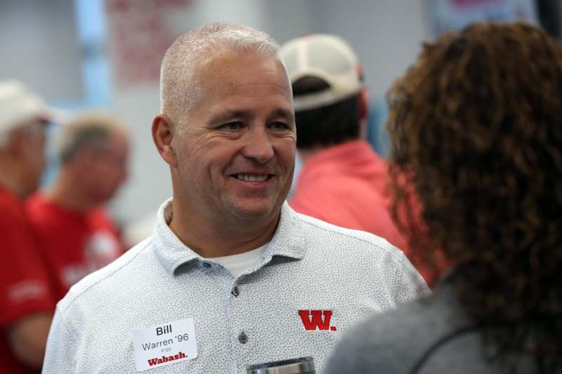 a man in a white shirt with a name tag