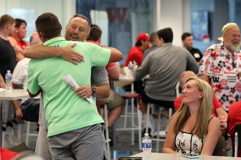 a man hugging another man