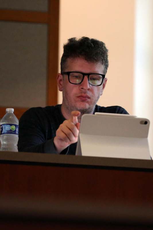 a man pointing at a tablet