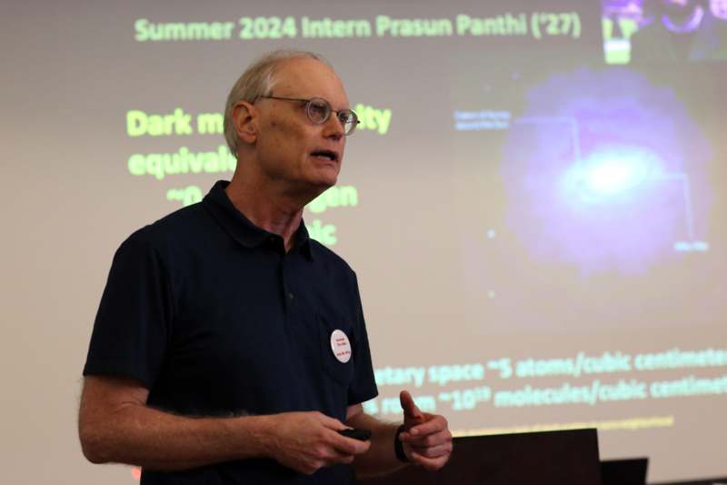 a man standing in front of a projection screen