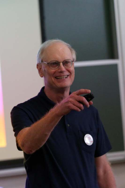 a man wearing glasses and a blue shirt