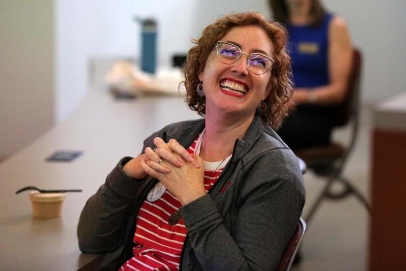 a woman laughing at a table