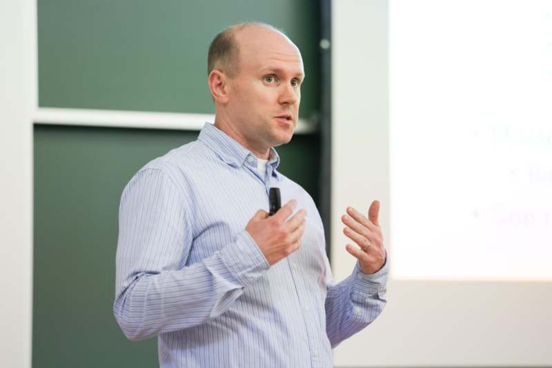 a man standing in front of a screen