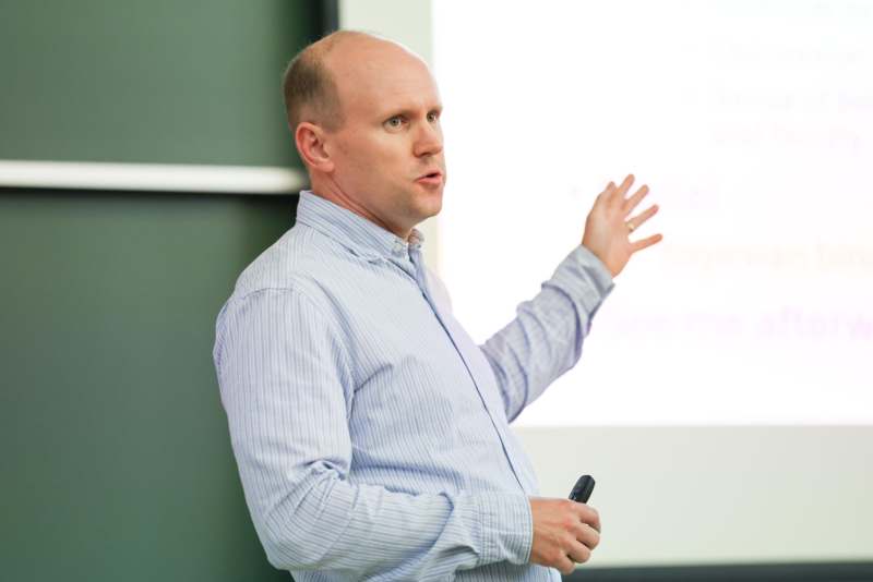 a man standing in front of a screen