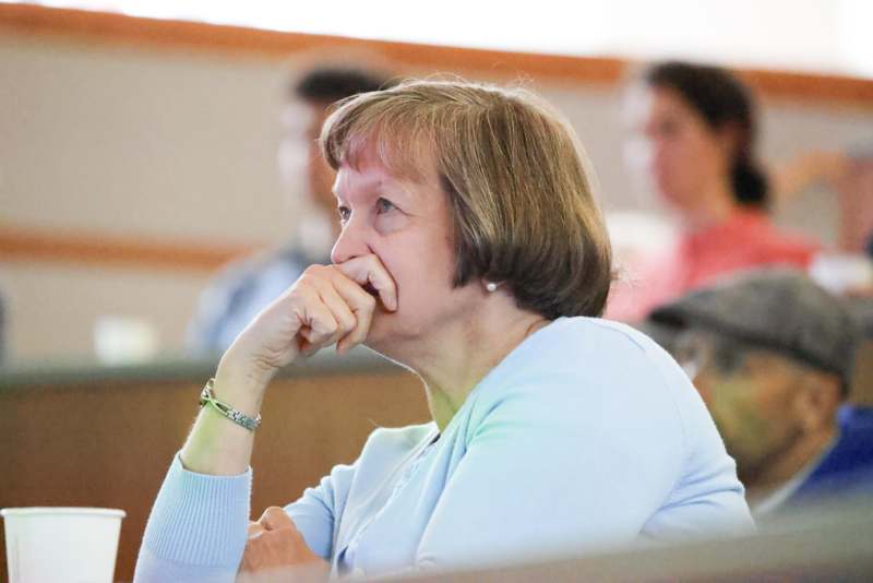 a woman with her hand on her mouth