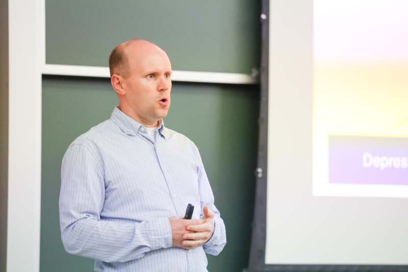 a man standing in front of a screen