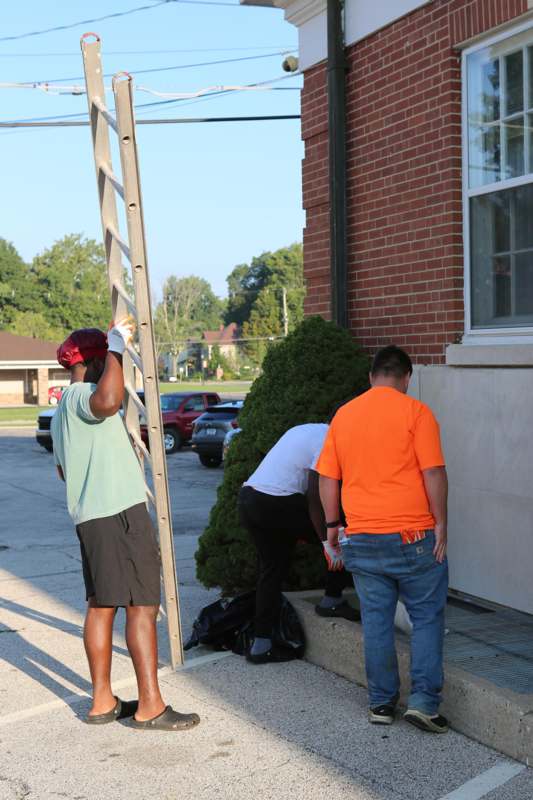 a group of men standing on a sidewalk