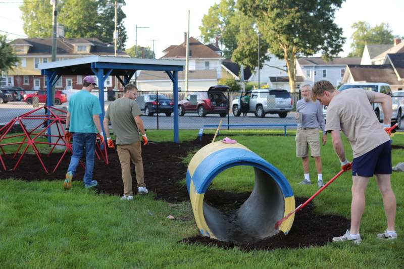 a group of people cleaning a hole in the ground