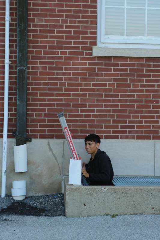 a man sitting in a window sill