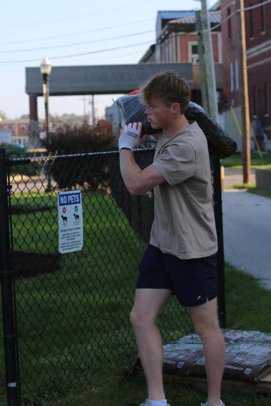 a man holding a bag of garbage