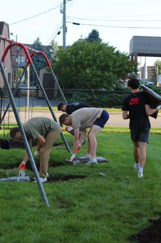 a group of men digging in the ground